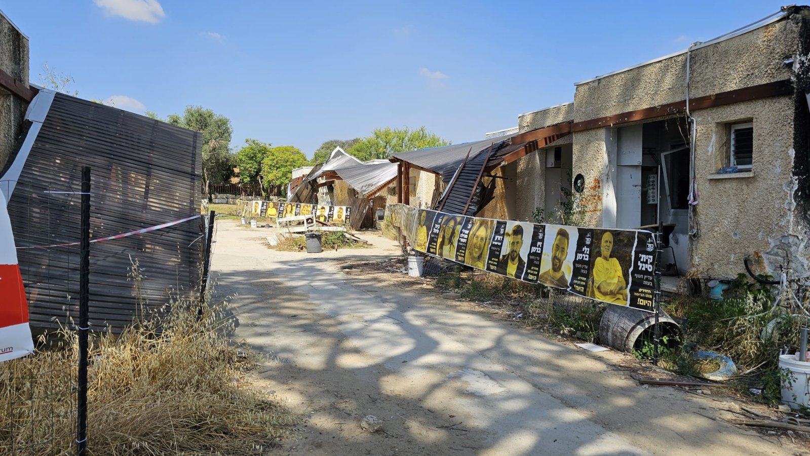 After Hamas attack, with damanged buildings posters