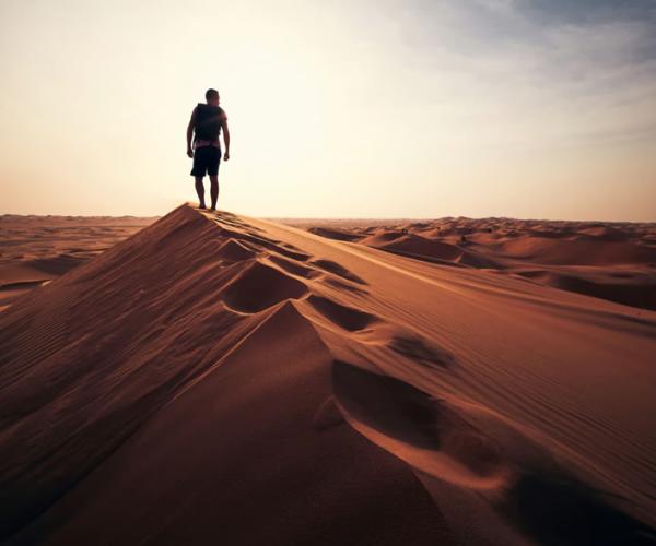 Man walking along a dune