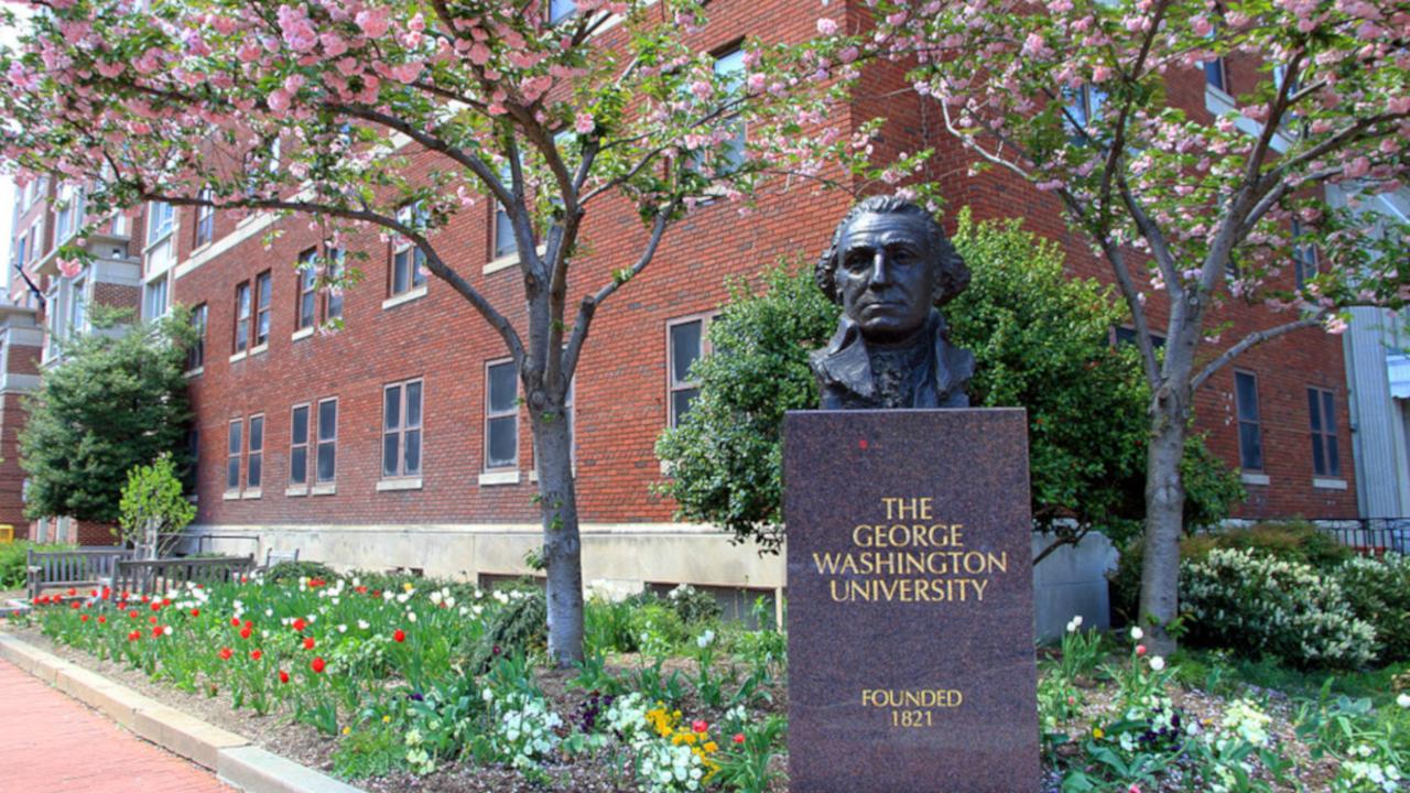 GWU campus with trees and bust of George Washington