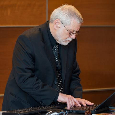 Edwin, black suit, laptop